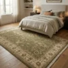 Bright modern bedroom with neutral linens and light wood floors, featuring a 6' x 9' olive and cream Chobi wool rug under the bed.