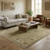 Bright modern living room with a cream tufted sofa and light wood floors, featuring a 6' x 9' sage and ivory Chobi wool rug.