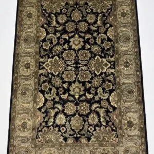 Full overhead view of a 5' 11" x 9' hand-knotted Indian wool rug featuring a symmetrical floral design on a black field with a wide olive-gold border.