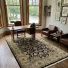 Sophisticated home office with a dark wood desk and leather armchairs, featuring a 5' 11" x 9' black and olive Indian wool rug.