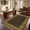 Sophisticated home office with a dark wood desk and leather armchairs, featuring a 5' 11" x 9' black and gold Indian wool rug.