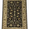 Full overhead view of a 5' x 8' hand-knotted Indian wool rug featuring a saturated black field with large-scale scrolling floral vines and an ornate ivory-tan border.