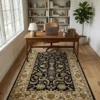 Sophisticated home office with a dark wood desk and leather armchair, featuring a 5' x 8' black and sage Indian wool rug.