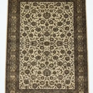 Full overhead view of a 6' x 8' 10" hand-knotted Indian wool rug featuring a symmetrical floral design on a black field with a wide olive-gold border.