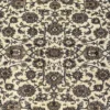 Macro shot of the dense hand-knotted wool pile showing mirrored sage green and tan floral palmettes on a black background.