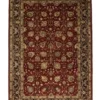 Full overhead view of a 6' x 9' hand-knotted Indian wool rug featuring a saturated ruby red field with intricate gold and ivory scrolling floral patterns and an ornate border.