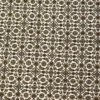 Macro shot of the dense hand-knotted wool pile showing delicate sage and tan floral motifs on a bright cream background.