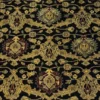 Macro shot of the dense hand-knotted wool pile showing intricate burgundy and sage floral motifs within a golden lattice on a black background.
