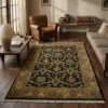 Sophisticated living room with leather furniture and wood floors, featuring a 6' x 9' black and gold Indian wool rug as a central anchor.