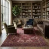 Elegant living room with a neutral sofa and light wood floors, anchored by a large red and sage Persian Heriz rug.
