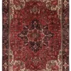 Full overhead view of an 8' 6" x 11' 1" hand-knotted Persian Heriz wool rug with a vibrant red field, large geometric medallion, and dark indigo corners.