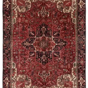 Full overhead view of an 8' 6" x 11' 1" hand-knotted Persian Heriz wool rug with a vibrant red field, large geometric medallion, and dark indigo corners.