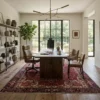 Professional home office with full-height metal shelving and a modern desk, anchored by a large red and indigo Heriz wool rug.