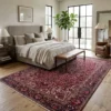 Spacious bedroom with a beige upholstered bed and natural wood accents, featuring a large Heriz rug providing a warm foundation under the bed.