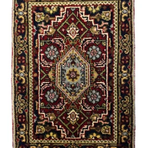 Overhead view of a 1' 3" x 2' 0" hand-knotted Indian wool rug with a detailed multi-layered medallion design in red, navy, and ivory.