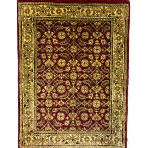 Overhead view of a 1' 8" x 2' 3" hand-knotted Indian wool rug with a deep burgundy floral field and an ornate gold and ivory botanical border.