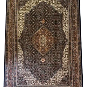 Full overhead view of a 6' 4" x 9' 8" hand-knotted Indian wool rug with a detailed central diamond medallion, dark charcoal field, and stepped cream spandrels.