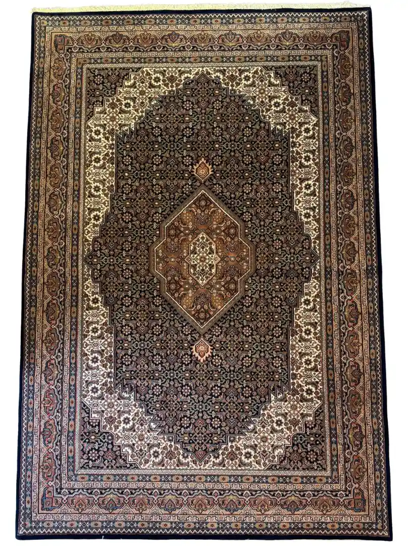 Full overhead view of a 6' 4" x 9' 8" hand-knotted Indian wool rug with a detailed central diamond medallion, dark charcoal field, and stepped cream spandrels.
