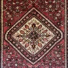 Macro shot of the dense hand-knotted wool pile on an Iranian Hosinabad rug, showcasing the sharp lines of the central cream and red diamond motif.
