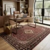 Professional home workspace with a walnut desk and tan leather chair, highlighted by a red and black Hosinabad Persian wool rug.