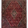 Full overhead view of a 7' 0" x 10' 0" hand-knotted Iranian Joshaghan wool rug with an intricate geometric diamond medallion on a saturated red and navy field.
