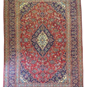 Full overhead view of a 6' 4" x 9' 6" hand-knotted Iranian Kashan wool rug with a detailed diamond medallion on a crimson field with navy borders.