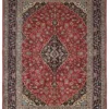 Full overhead view of a 9' 6" x 12' 5" hand-knotted Persian Kashan wool rug featuring a large navy central medallion on a vibrant red field with a wide floral border.