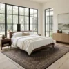 Serene minimalist bedroom with a walnut bed frame and white linens, featuring a long brown and white Persian Mahi wool rug running beside the bed lane.