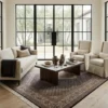 Bright transitional living room with a green tufted leather sofa and oak coffee table, highlighted by a brown and white hand-knotted Persian Mahi rug under a low coffee table.