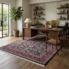 Modern home office with a dark wood desk and leather chair, featuring a 7x11 navy Persian Mood wool rug on light oak floors.