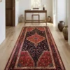 Wide residential hallway with oak floors leading to a minimalist writing desk, defined by a long red and navy hand-knotted Nahavand rug.