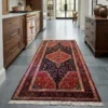 Upscale modern galley kitchen with warm walnut cabinetry and dark slate floor tiles, anchored by a long red and navy Persian Nahavand rug runner.