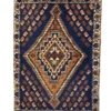 Overhead view of a 1' 7" x 2' 3" hand-knotted Iranian Qashqai wool rug featuring a deep navy field with three geometric medallions and burnt orange accents.