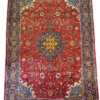 Full overhead view of a 6' 8" x 10' 2" hand-knotted Iranian Sarough wool rug with an intricate central medallion on a vibrant cherry-red floral field.