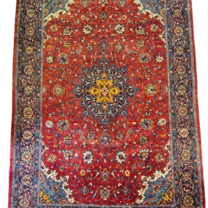 Full overhead view of a 6' 8" x 10' 2" hand-knotted Iranian Sarough wool rug with an intricate central medallion on a vibrant cherry-red floral field.