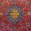 Macro shot of the dense hand-knotted wool pile on an Iranian Sarough rug, showcasing the radiating gold and blue patterns of the central medallion.
