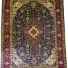 Full overhead view of a 6' 10" x 9' 6" hand-knotted Iranian Tabriz wool rug with an intricate central medallion on a warm camel and soft red field.