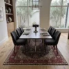 Elegant open-concept dining room featuring a long wooden dining table and beige upholstered chairs, centered over a 7x10 Tabriz rug under a massive arched window.