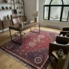 Professional home workspace with a walnut desk and brown leather chair, highlighted by a red and plum hand-knotted Persian rug.