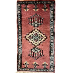Overhead view of a 1' 0" x 2' 0" hand-knotted Pakistan Jaldar wool rug featuring a rose-terracotta field with three geometric diamond medallions.