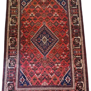 Full overhead view of a 6' 6" x 9' 10" hand-knotted Persian Joshaghan wool rug K108 featuring a signature diamond medallion on a vibrant red field.