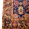 Technical corner shot of a blue and gold Iranian Khalkhal rug showcasing the bold geometric outer border guard and neatly bound edge finish.