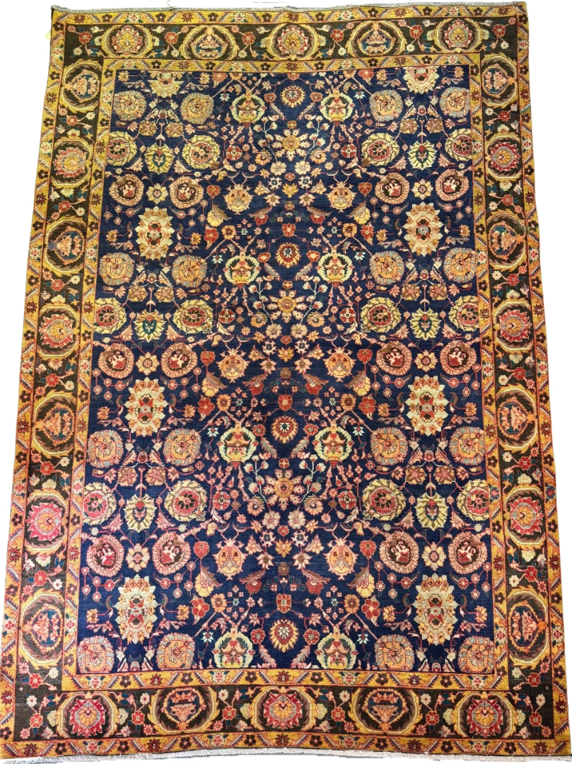 Full top-down overview of a 7' 2" x 10' 9" hand-knotted Iranian Khalkhal wool rug with an all-over floral layout on a deep midnight blue field with golden-yellow borders.