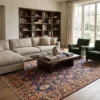 Airy contemporary living room with a large linen sectional couch and dark wood coffee table, anchored by a 7x11 blue and gold Persian Khalkhal rug.