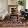 Serene fireside sitting room with a light cream sofa and two black leather club chairs, centered over an all-over floral Khalkhal area rug.