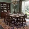 Stately formal dining room with a grand mahogany table and matching chairs, grounded by a blue and gold 7x11 Persian Khalkhal carpet.