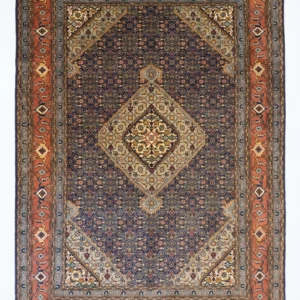 Full overhead view of a 6' 6" x 9' 10" hand-knotted Iranian Mahi wool rug with a detailed central diamond medallion on a midnight blue, burnt orange, and amber yellow repeating fish pattern field.
