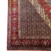 Detailed corner view of a Persian Seneh rug highlighting the dense multi-guard border, dark field patterns, and neat fringe lines.