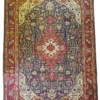 Full overhead view of a 6' 10" x 9' 10" hand-knotted Iranian Tabriz wool rug with an intricate central medallion on a midnight navy field with red and cream borders.