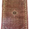 Full view of a 6' 7" x 10' 0" hand-knotted Persian Hoseinabad wool rug with an intricate diamond medallion and traditional red and cream patterned borders.